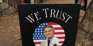 Sign reading We Trust Dr. Fauci on display.