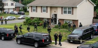Law enforcement officers conducting a raid in a residential neighborhood