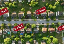 Did This Governor Just ELIMINATE Property Taxes?! Aerial view of neighborhood with Sold signs on houses.