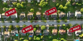 Aerial view of neighborhood with Sold signs on houses.