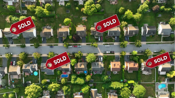 2461025321-1 Aerial view of neighborhood with Sold signs on houses.
