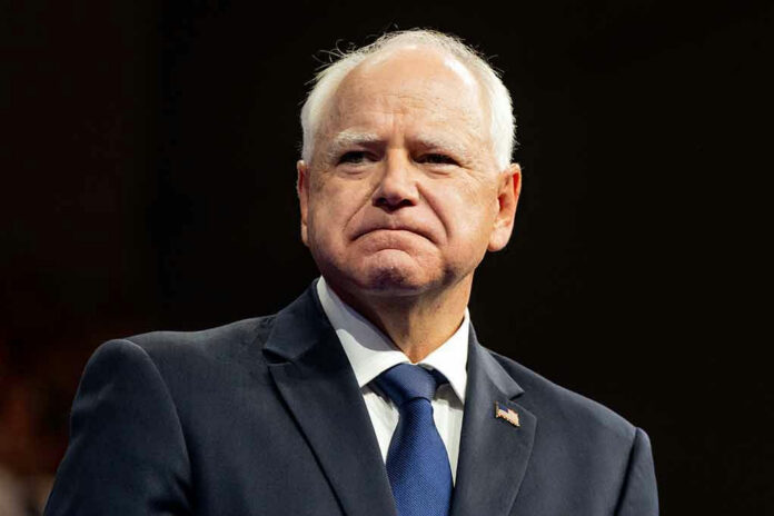 2499464677 Man in suit with American flag pin.