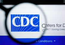Quiet Trump ORDER Upends CDC Playbook… Magnifying glass over CDC logo on a website.