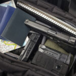 Handgun and magazines in an open travel bag