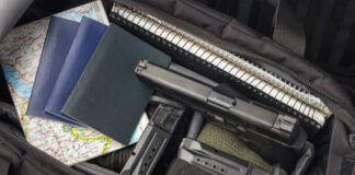 Handgun and magazines in an open travel bag