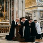 Pope’s SCARY AI Warning: Who’s Really in Control? Clergy members kneeling in prayer inside a grand cathedral