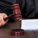 Arrest Trap Exposed — Judge Hits Pause Judge striking gavel near documents and pen.