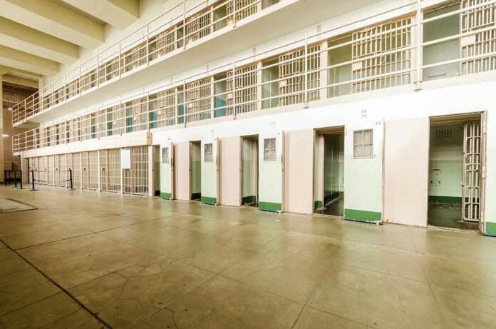 206092135 Empty prison cells in a hallway.