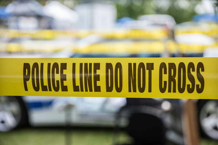 Yellow police tape that says, Police Line Do Not Cross.