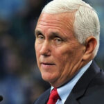 Former VP Pence Slams Trump man with short white hair speaking at a podium
