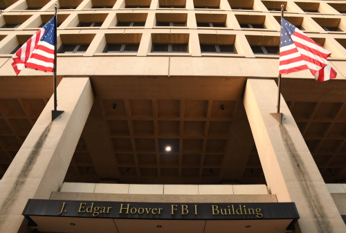 Exterior view of the J. Edgar Hoover FBI Building with American flags