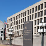 United States Department of Labor building exterior with sign and flags