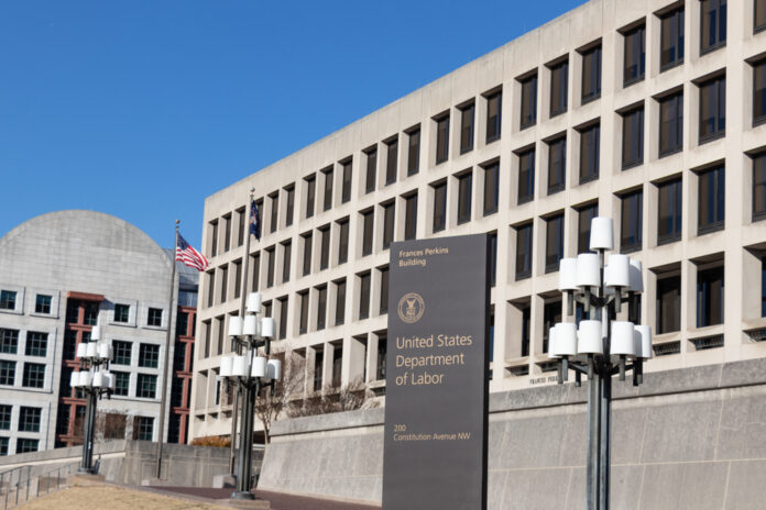Washington,,Dc,,Usa,-,December,11,,2019:,Sign,On,Constitution United States Department of Labor building exterior with sign and flags