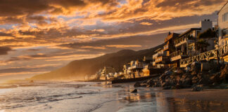 Coastal view at sunset with homes along the shore