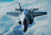 Stealth fighter jet flying above the clouds.