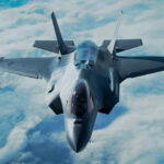 Stealth fighter jet flying above the clouds.