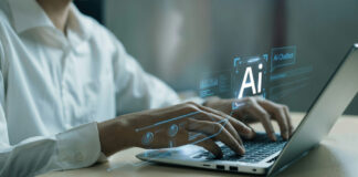 Hands typing on laptop with AI holograms.