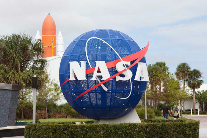 742595803 NASA globe sculpture with rocket in background.