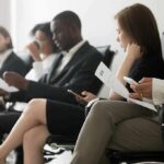 Ink-For-Interview Backlash Rattles SF Startup Job applicants seated in a waiting area reviewing documents