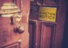 Outrage in Baltimore: Pay-To-Get Home Back Weathered wooden door with eviction notice
