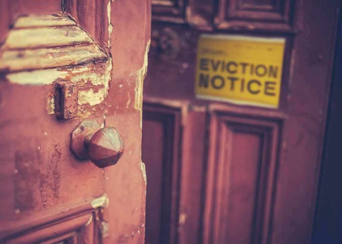 shutterstock_1173553150 Weathered wooden door with eviction notice