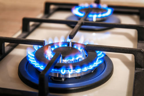 shutterstock_1660250275-1- Close-up of two lit gas stove burners.