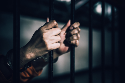 Portrait,Of,Women,Desperate,To,Catch,The,Iron,Prison,prisoner,Concept,thailand Hands gripping prison bars, suggesting confinement
