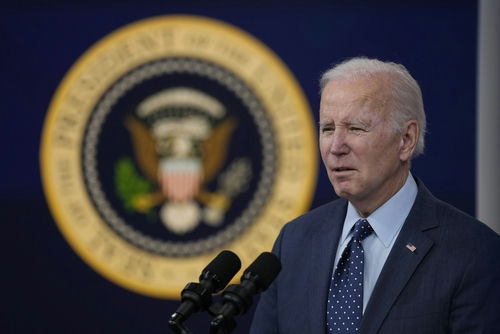 shutterstock_2266516973 A man speaking in front of presidential seal.