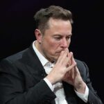 Far-Right Tag? Musk Flips The Script man in suit with hands steepled in thought