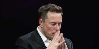 man in suit with hands steepled in thought