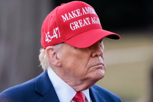 Washington,-,Feb,28,2025:,President,Donald,Trump,Speaks,To A man wearing a red cap with a political slogan, looking serious