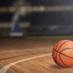 Unexpected NYC Move Stirs NBA Tensions A basketball on a wooden court