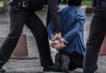 Police officers arresting a suspect in handcuffs
