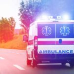 A Hidden Battery Danger Claims A Young Life Ambulance van with flashing lights on a rural road
