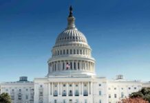 United States Capitol building with dome under clear blue sky