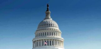 United States Capitol building with dome under clear blue sky