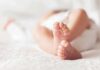 baby feet on a soft white blanket