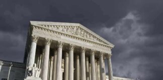 United States Supreme Court building with columns under stormy sky
