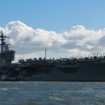 Combat Costs Force Tough Choices Behind The Scenes Aircraft carrier at sea with fighter jets on deck