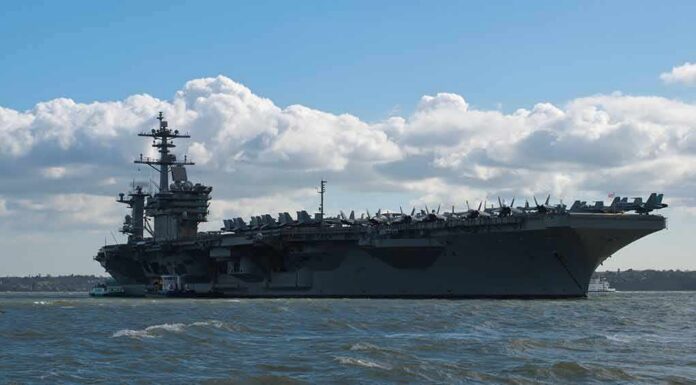 shutterstock_1347055766 Aircraft carrier at sea with fighter jets on deck