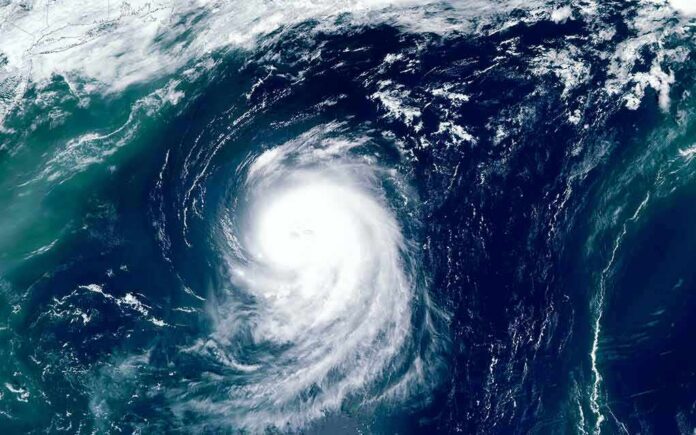 shutterstock_1493291597 Satellite view of a powerful hurricane swirling over the ocean