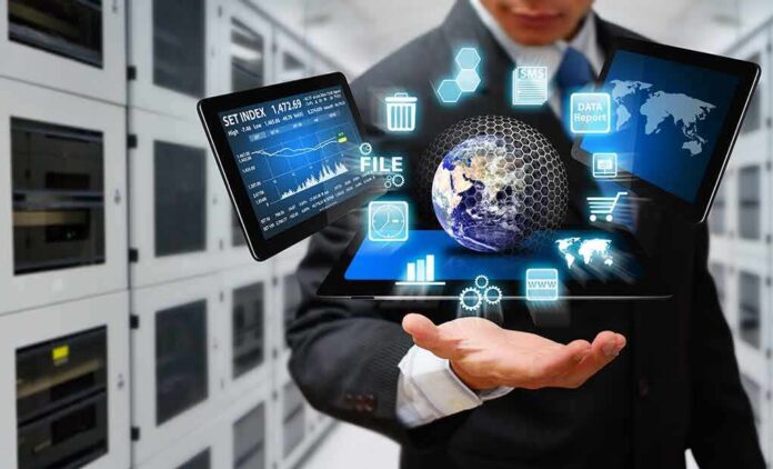 shutterstock_152663261 Businessperson holding a digital tablet with floating data icons