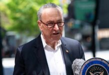 One Funding Decision Tears Open A Party Rift man in suit speaking at outdoor press event