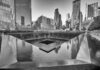 Pentagon Over Ground Zero — Here’s Why A memorial water feature surrounded by tall buildings in a city