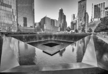 Pentagon Over Ground Zero — Here’s Why A memorial water feature surrounded by tall buildings in a city