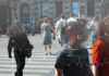 Biometric Dragnet Hits Italy’s Streets Crowd crossing a city street with digital tracking overlays