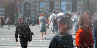 Crowd crossing a city street with digital tracking overlays