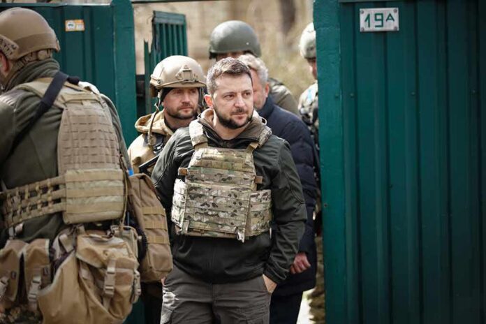 man in tactical vest walking with soldiers