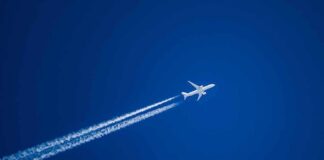 Airplane leaving contrails in a clear blue sky