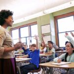 Connecticut Put Religion Into Law. Critics Pounced Teacher engaging with students raising hands in a classroom